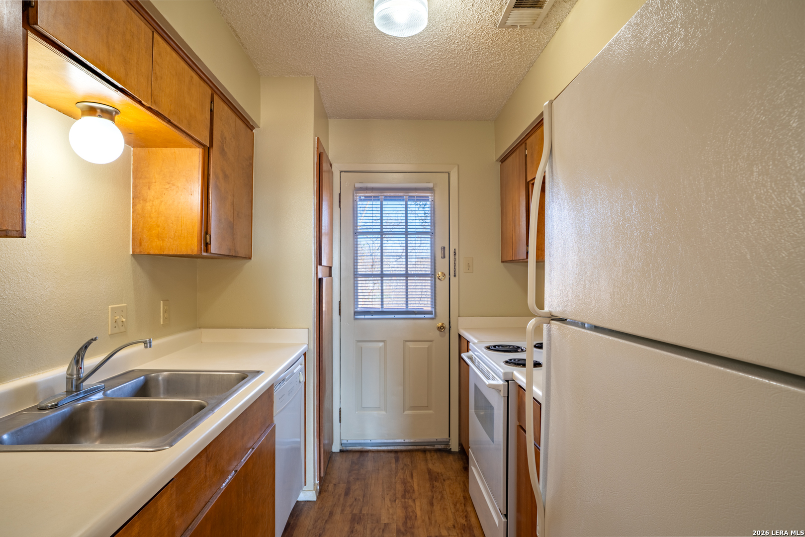 112 Blue Ridge Comfort, TX 78013 - Photo 5 of 11 a kitchen that has a sink a stove and a refrigerator
