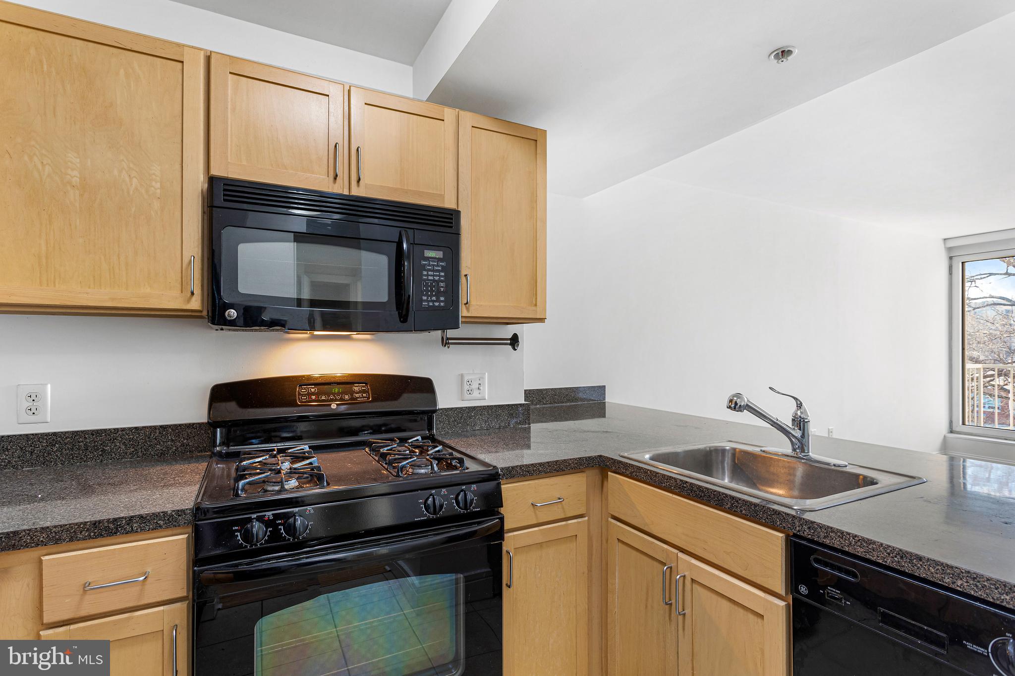 800 4th Street Southwest, Unit S425 Washington, DC 20024 - Photo 13 of 27 a kitchen with a sink stove and microwave