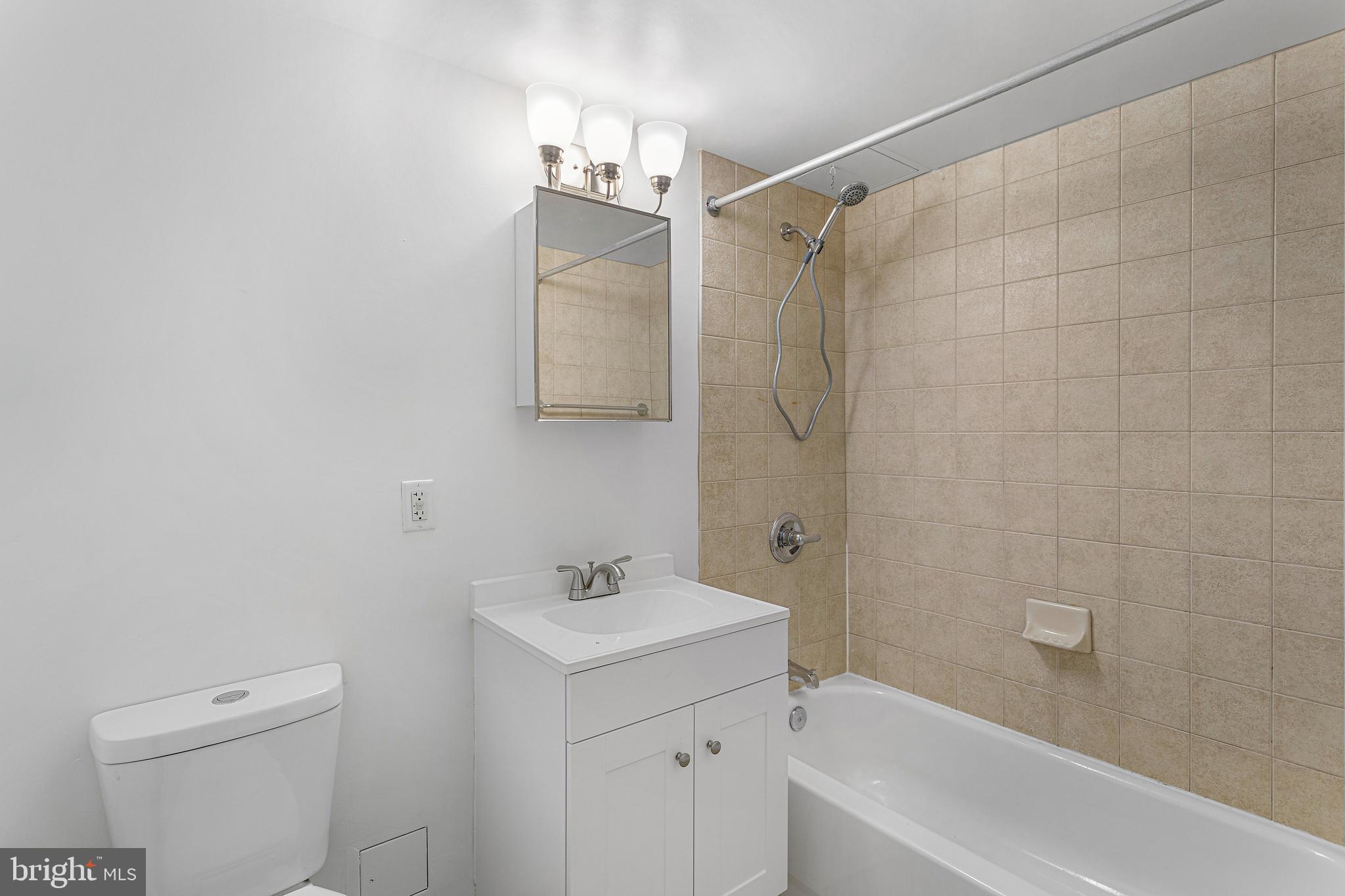 800 4th Street Southwest, Unit S425 Washington, DC 20024 - Photo 17 of 27 a bathroom with a sink a toilet and shower