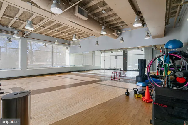 a dining room with furniture and a floor to ceiling window
