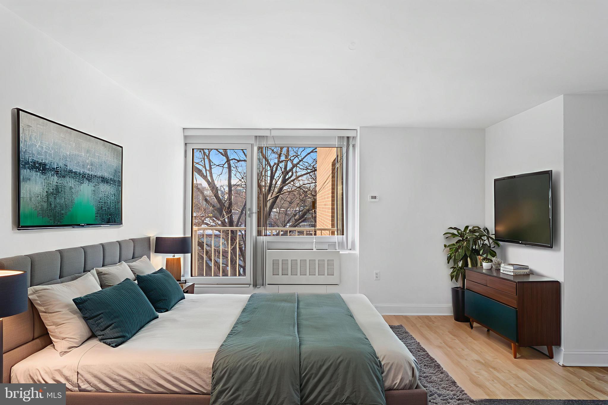 800 4th Street Southwest, Unit S425 Washington, DC 20024 - Photo 4 of 27 a bedroom with a bed and a flat screen tv