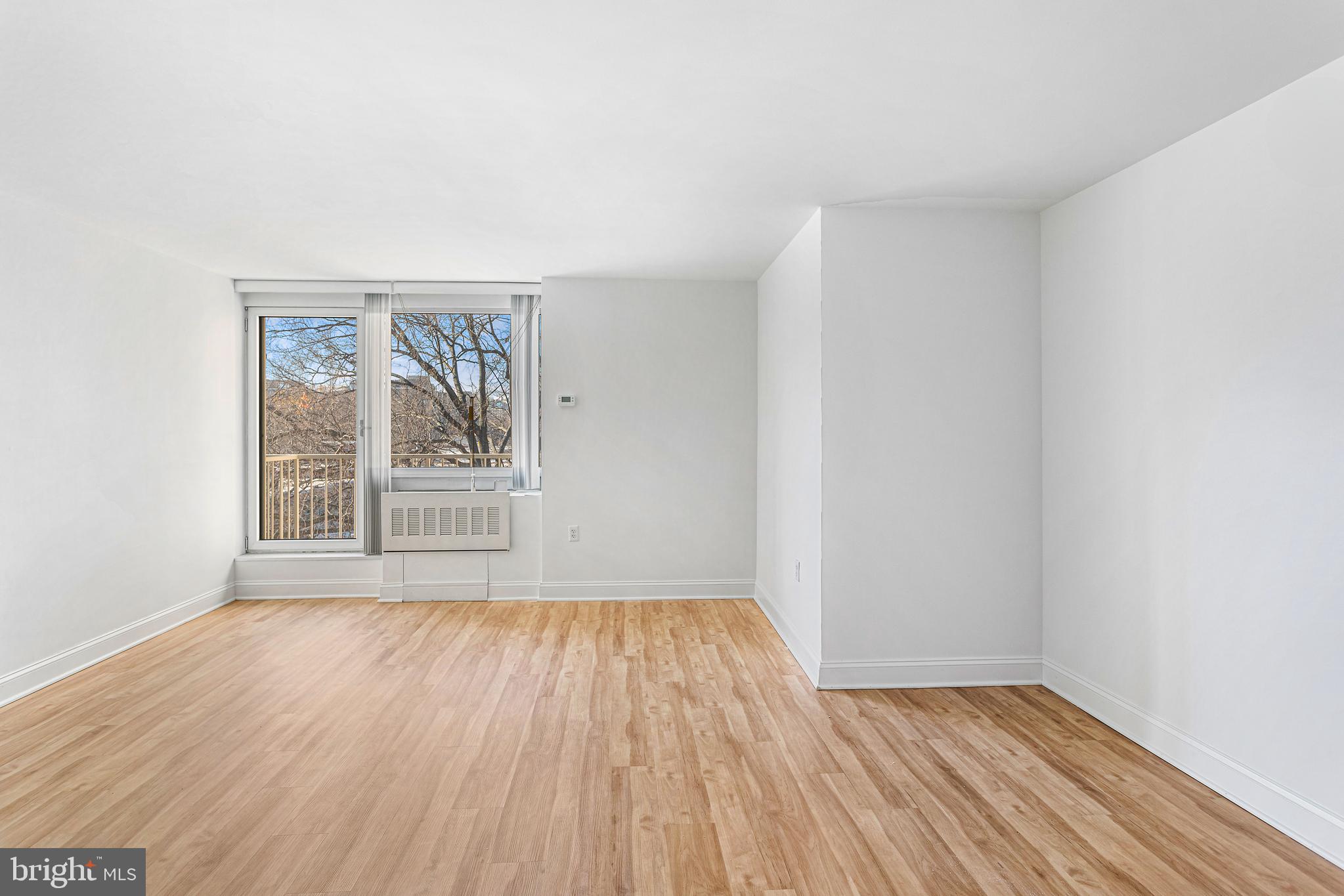 800 4th Street Southwest, Unit S425 Washington, DC 20024 - Photo 5 of 27 an empty room with wooden floor and windows