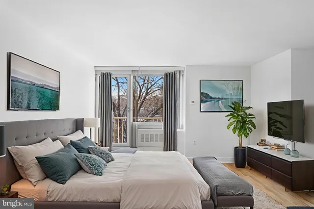 a bedroom with a bed and a flat screen tv