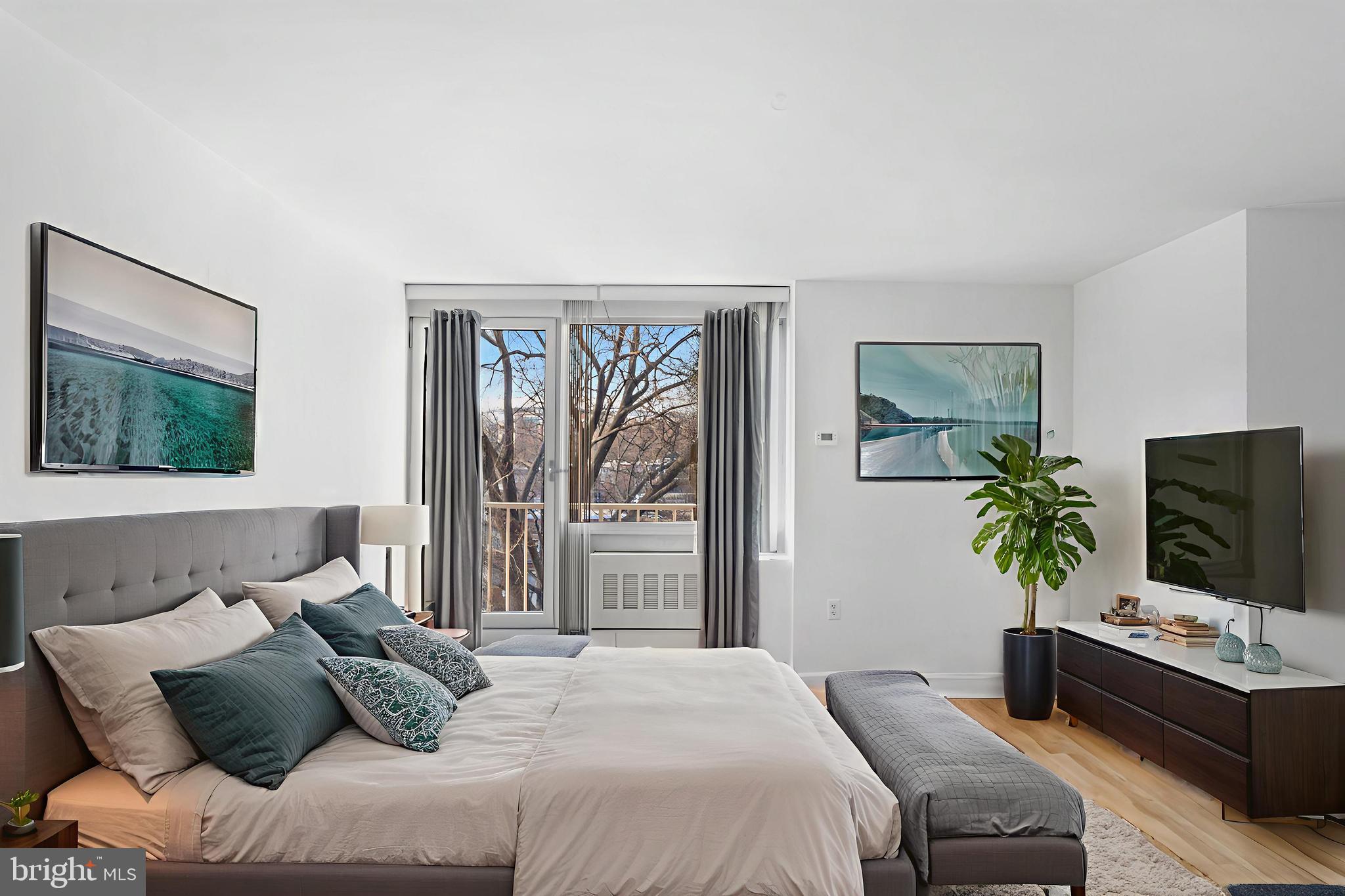 800 4th Street Southwest, Unit S425 Washington, DC 20024 - Photo 7 of 27 a bedroom with a bed and a flat screen tv