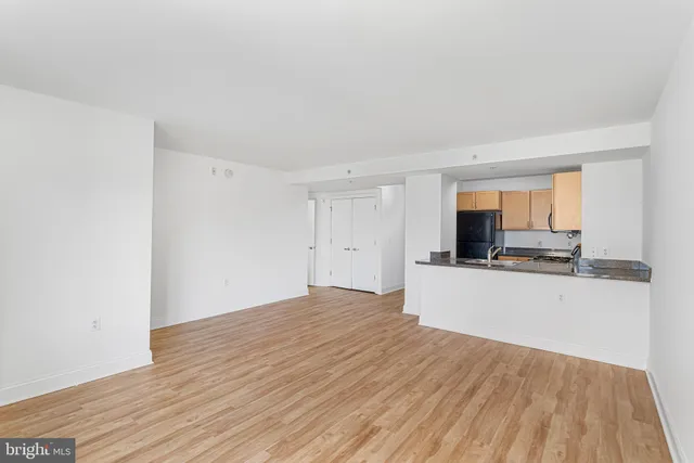 a view of a kitchen with wooden floor and a sink