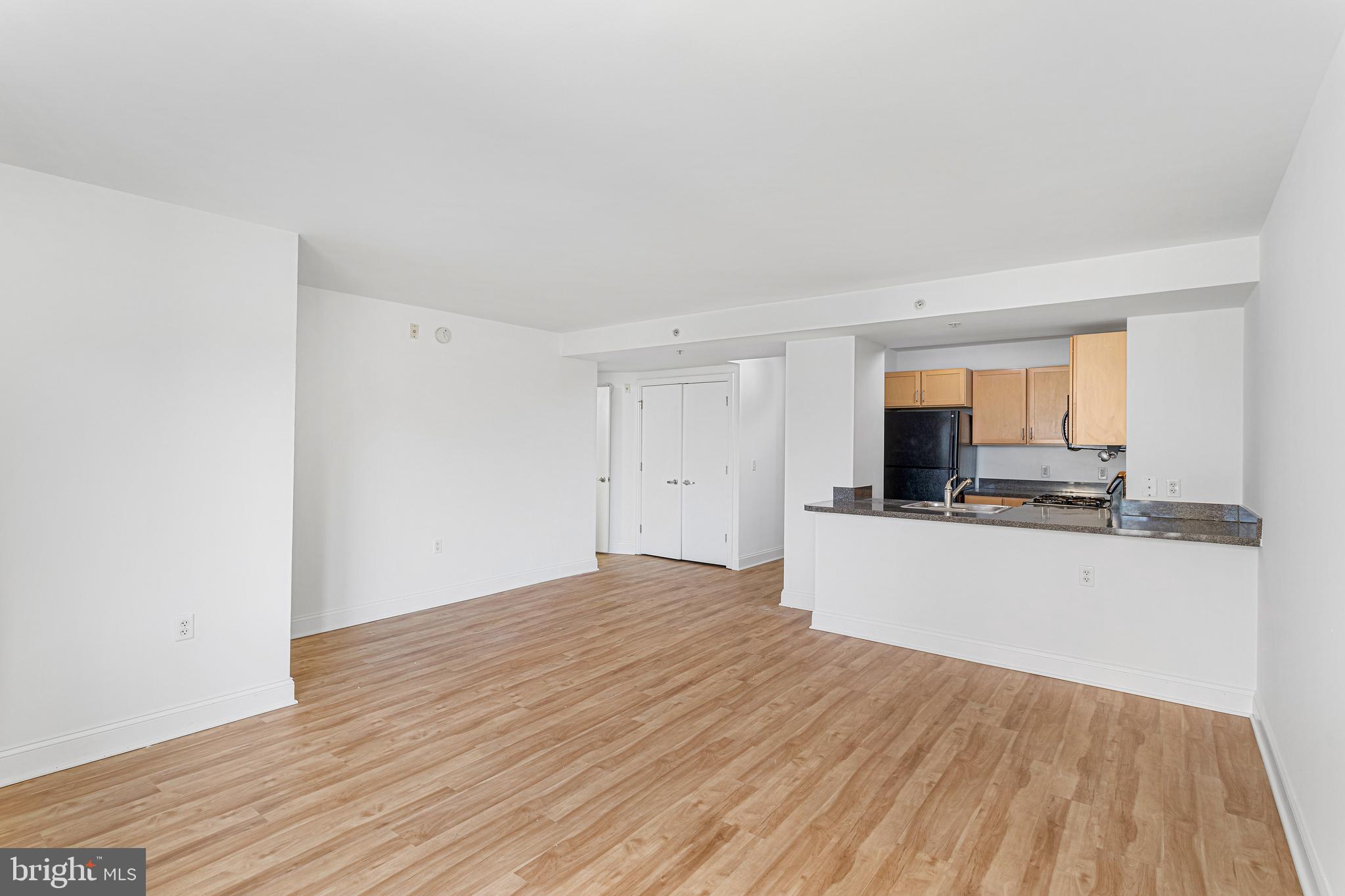 800 4th Street Southwest, Unit S425 Washington, DC 20024 - Photo 9 of 27 a view of a kitchen with wooden floor and a sink