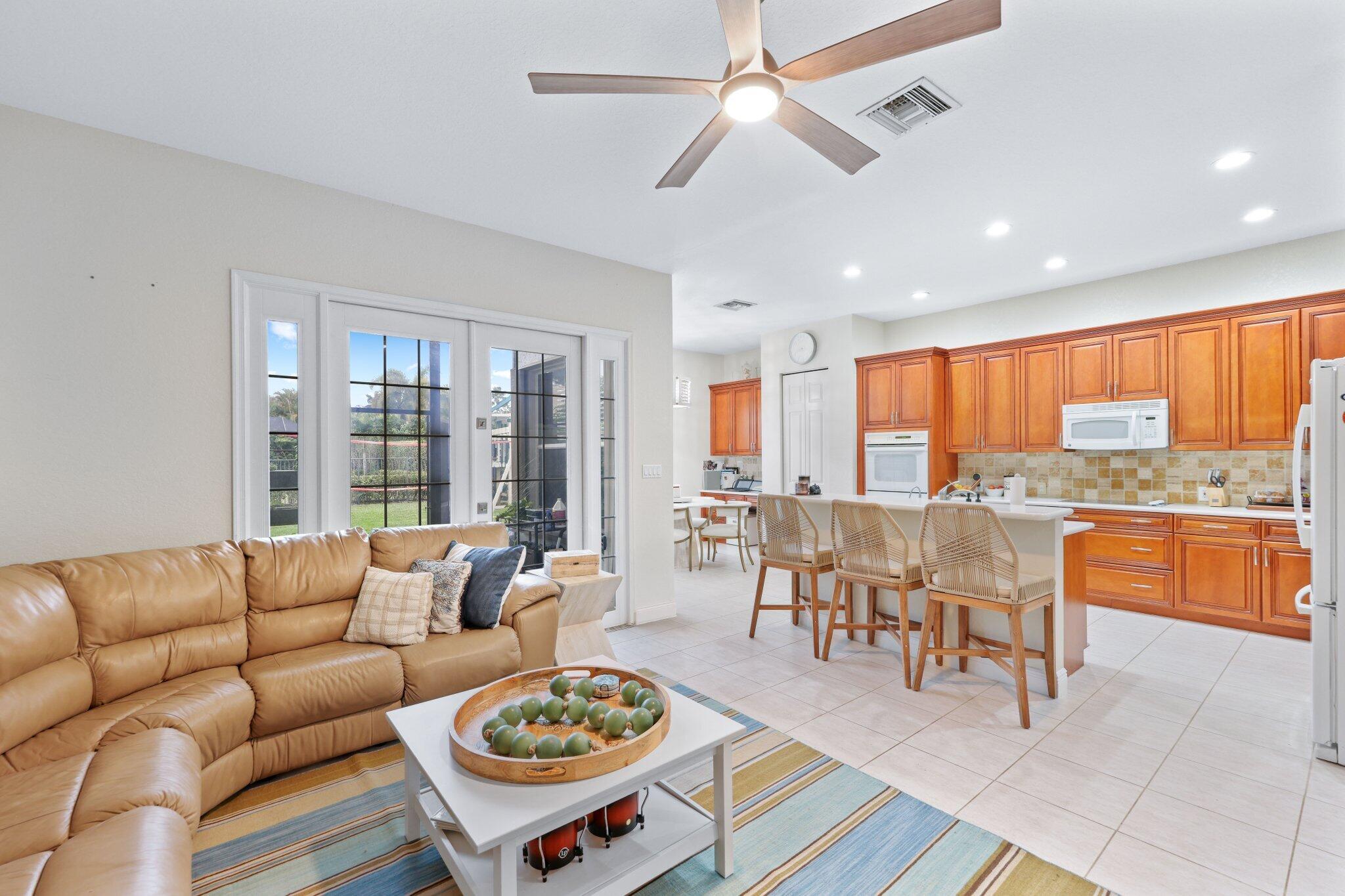 19090 Skyridge Circle Boca Raton, FL 33498 - Photo 12 of 70 a living room with furniture a wooden floor and a window