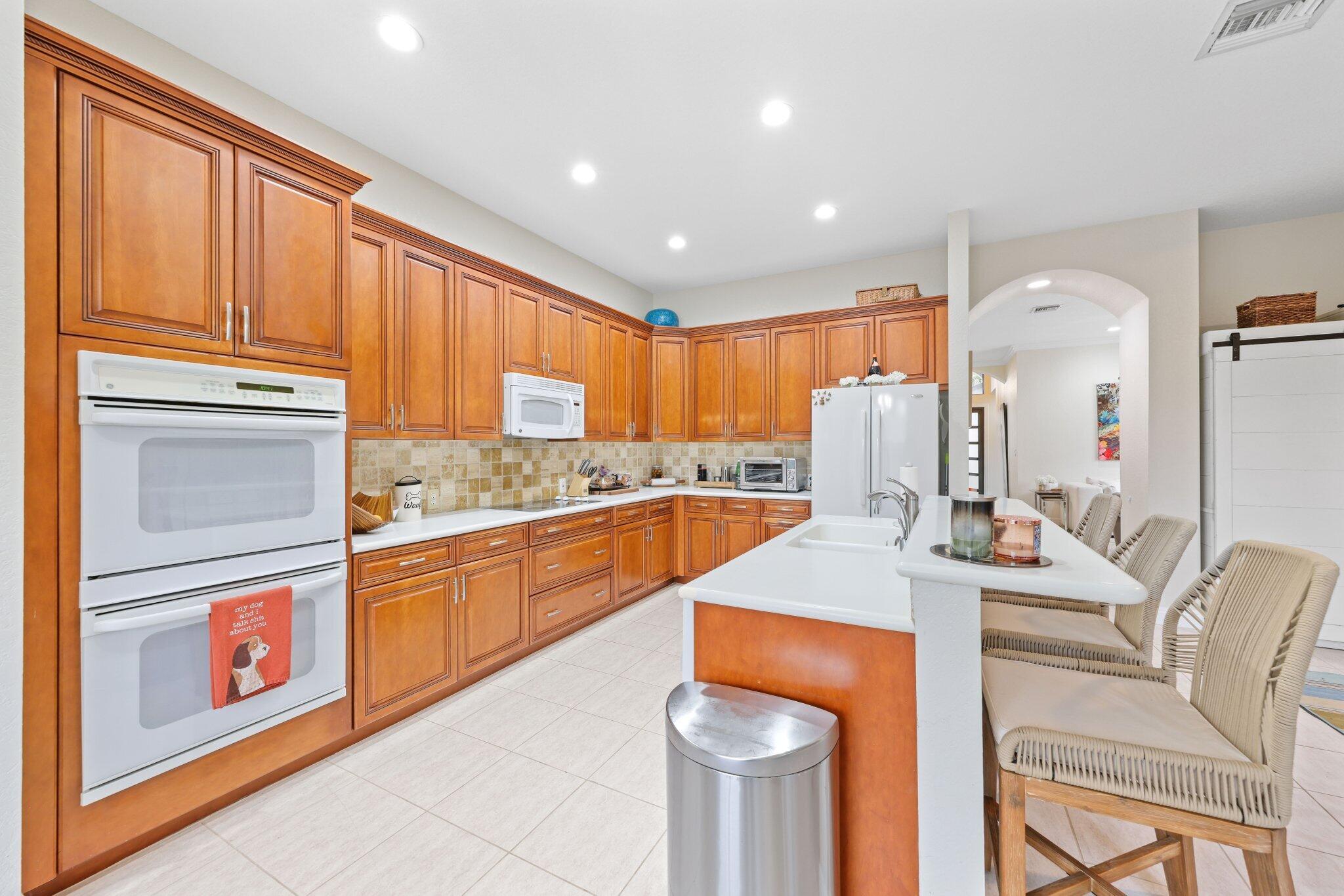 19090 Skyridge Circle Boca Raton, FL 33498 - Photo 16 of 70 a kitchen with stainless steel appliances granite countertop a sink refrigerator and cabinets
