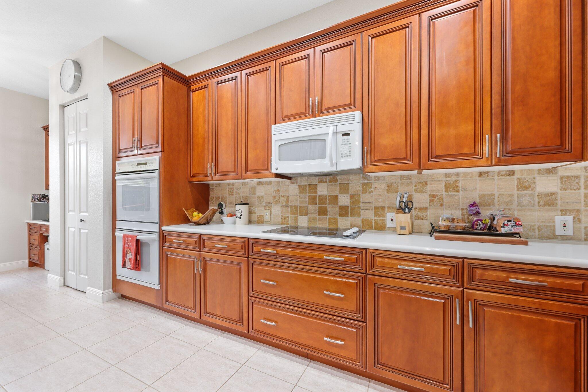 19090 Skyridge Circle Boca Raton, FL 33498 - Photo 19 of 70 a kitchen with stainless steel appliances granite countertop a sink a refrigerator and cabinets