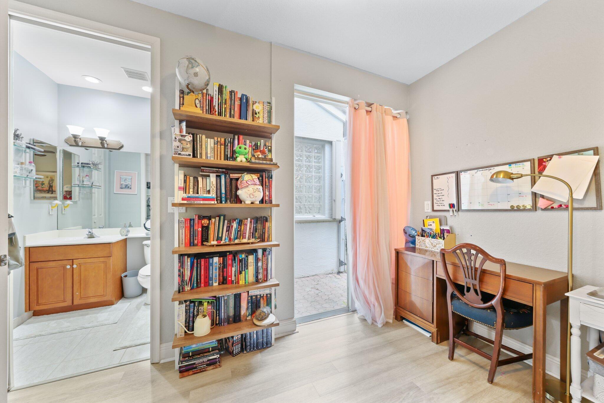 19090 Skyridge Circle Boca Raton, FL 33498 - Photo 28 of 70 a view of a workspace with furniture and a bookshelf