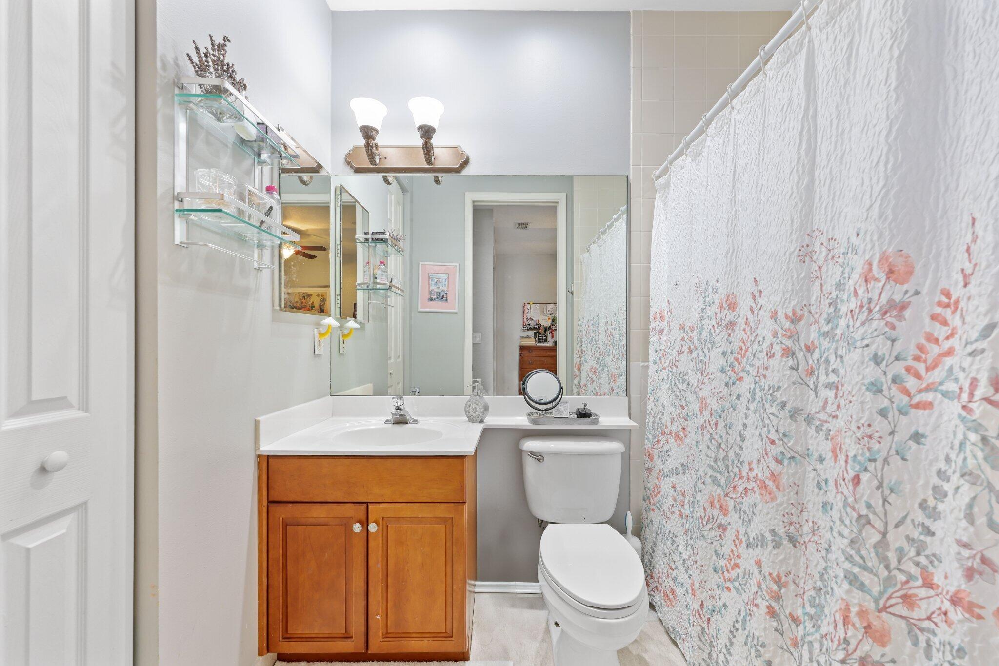 19090 Skyridge Circle Boca Raton, FL 33498 - Photo 29 of 70 a bathroom with a toilet sink and mirror