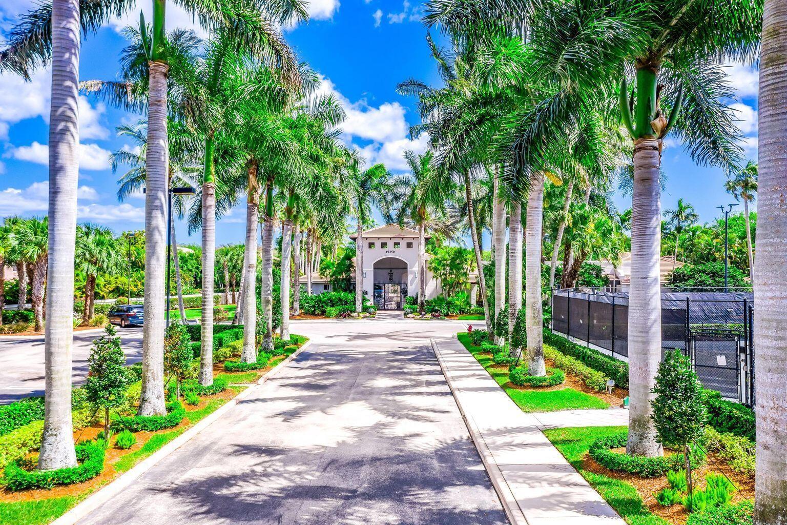 19090 Skyridge Circle Boca Raton, FL 33498 - Photo 60 of 70 a front view of a house with a yard and potted plants