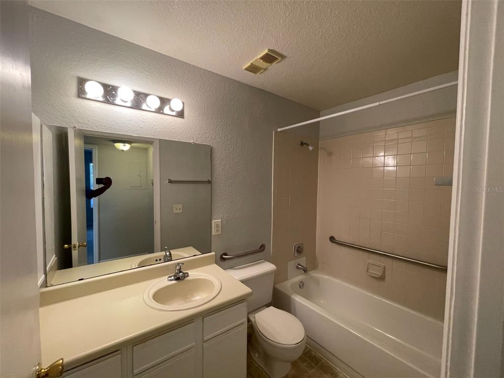 1063 South Hiawassee Road, Unit 1624 Orlando, FL 32835 - Photo 14 of 20 a bathroom with a sink a toilet and shower