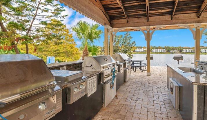 1063 South Hiawassee Road, Unit 1624 Orlando, FL 32835 - Photo 17 of 18 a view of a chairs and table in patio with a barbeque