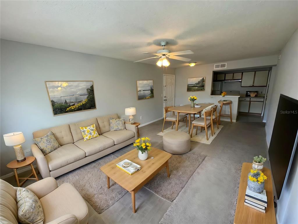 1063 South Hiawassee Road, Unit 1624 Orlando, FL 32835 - Photo 5 of 20 a living room with furniture potted plant and a window