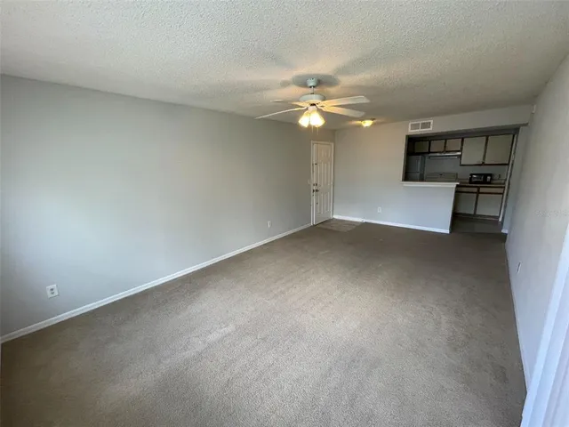 a view of empty room with a ceiling fan and window