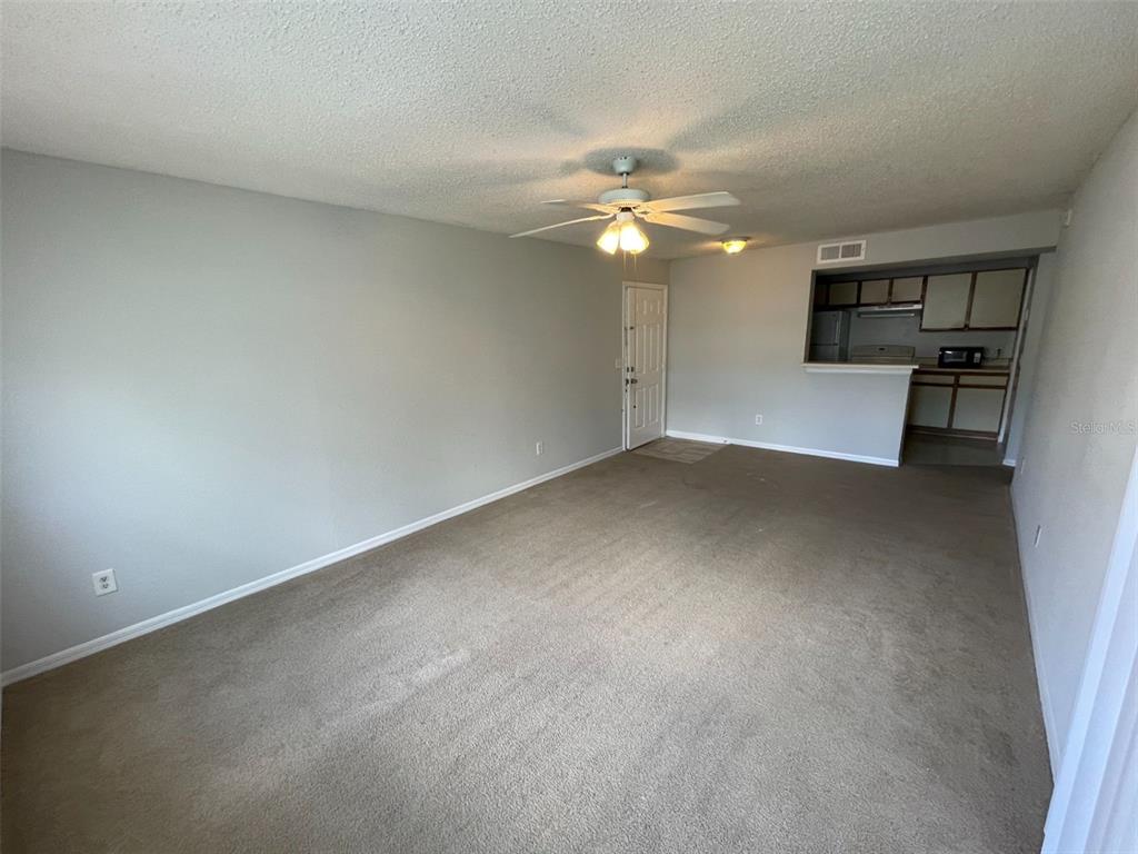 1063 South Hiawassee Road, Unit 1624 Orlando, FL 32835 - Photo 5 of 18 a view of empty room with a ceiling fan and window