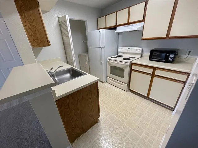a kitchen with stainless steel appliances a refrigerator stove and sink