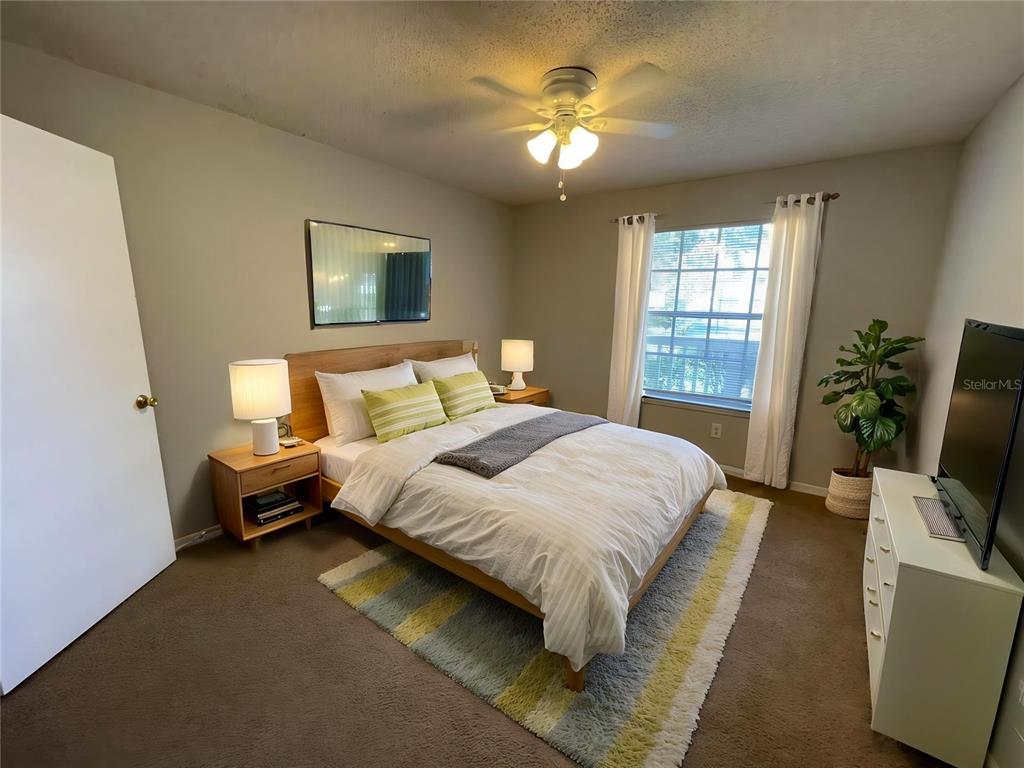 1063 South Hiawassee Road, Unit 1624 Orlando, FL 32835 - Photo 10 of 20 a bedroom with a bed and a chandelier