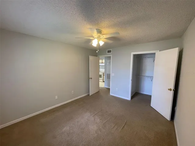 a view of an empty room with a ceiling fan