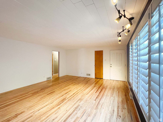 3138 Jean Street Magna, UT 84044 - Photo 6 of 26 Hardwood flooring throughout featuring white walls and a white paneled ceiling