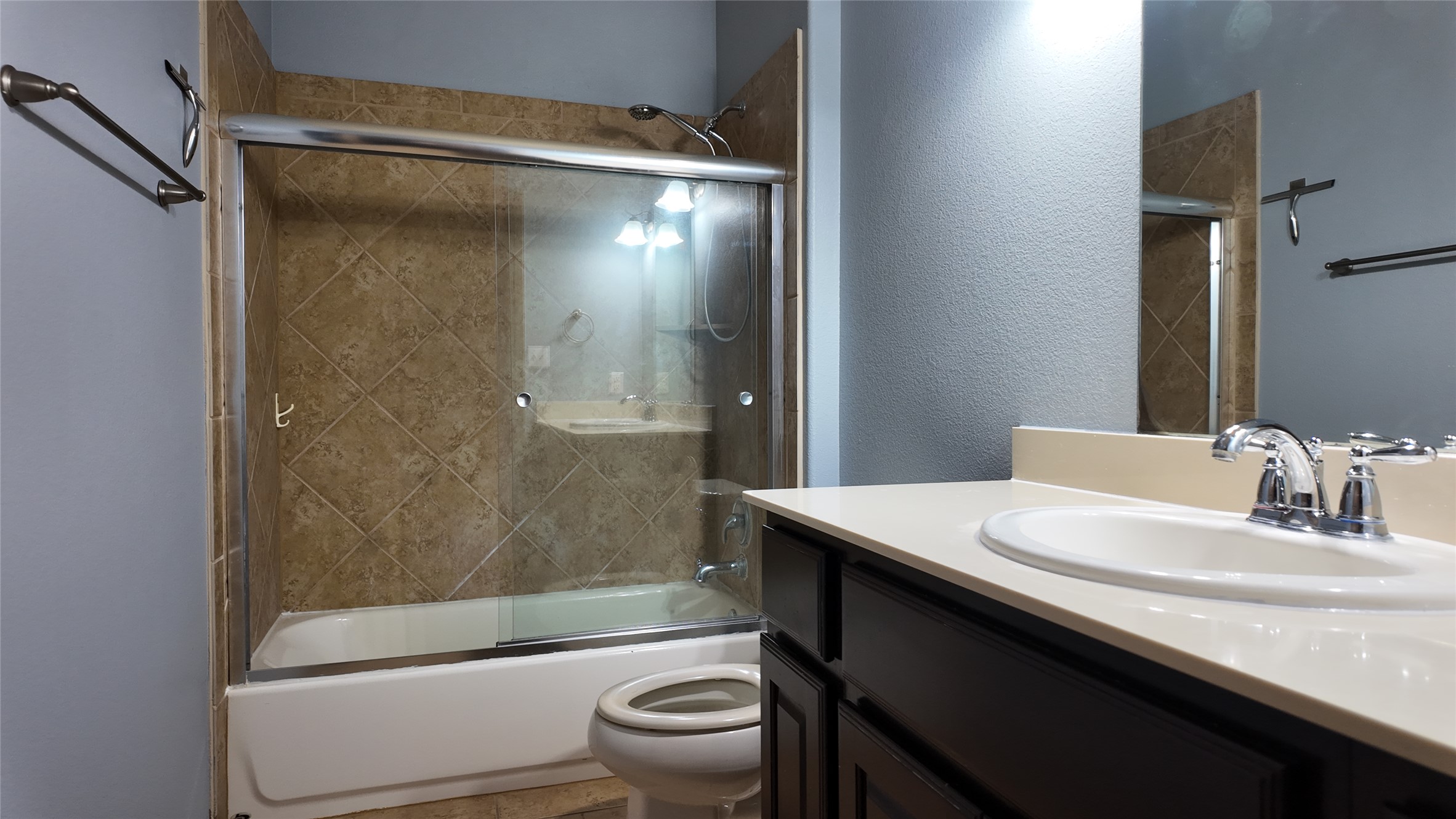1601 Nelson Ranch Loop Cedar Park, TX 78613 - Photo 16 of 25 Full bathroom featuring vanity, enclosed tub / shower combo, and a textured wall