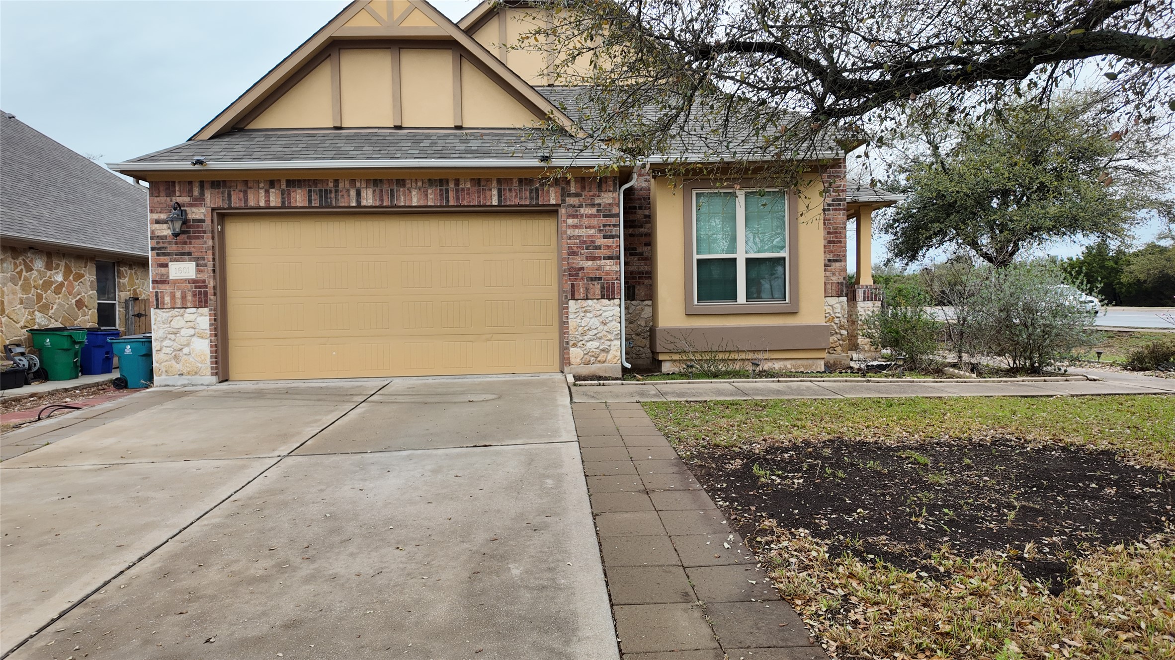 1601 Nelson Ranch Loop Cedar Park, TX 78613 - Photo 2 of 25 View of front of house featuring concrete driveway, a garage, roof with shingles, and brick siding