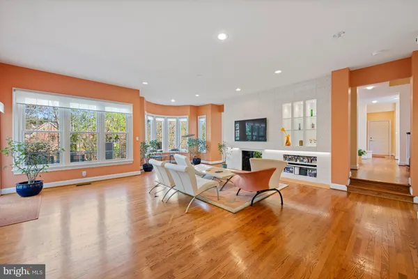 a living room with furniture and large windows