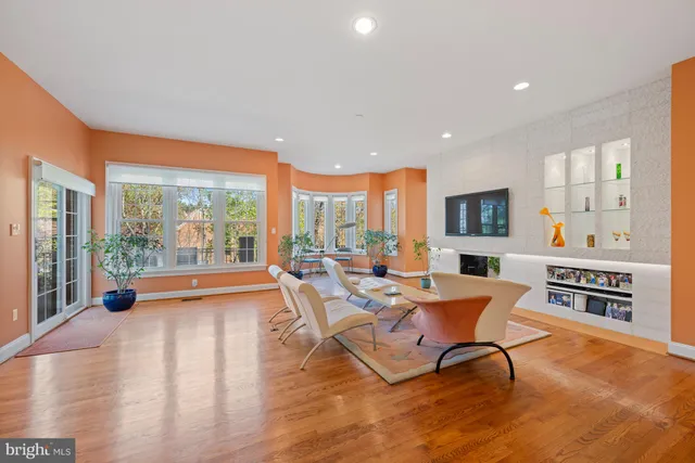 a living room with fireplace furniture and a large window