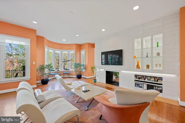 a living room with fireplace furniture and a flat screen tv