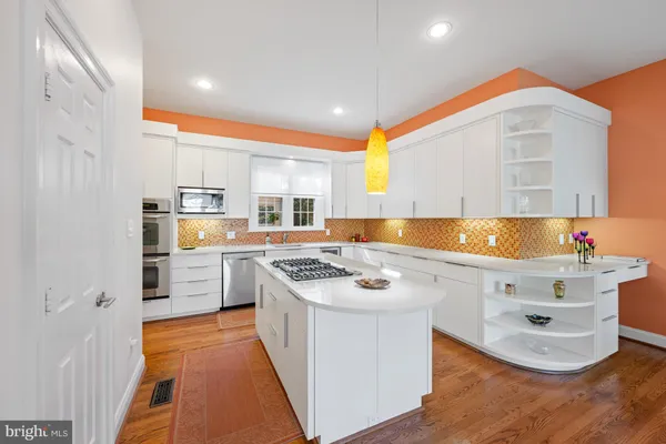 a kitchen with a stove a sink and a refrigerator