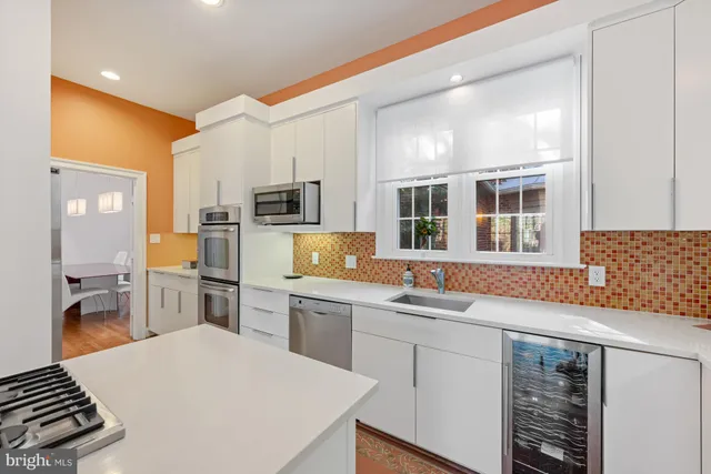 a kitchen with a sink stove and refrigerator