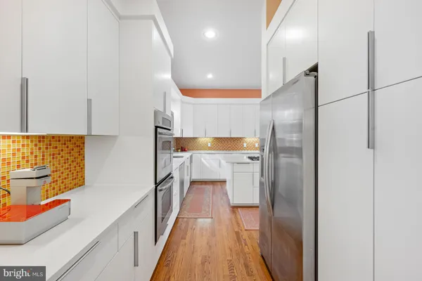 a kitchen with stainless steel appliances granite countertop a refrigerator and a sink