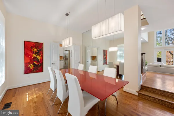 a view of a dining room with furniture a chandelier and wooden floor