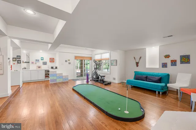 a view of a living room and kitchen with furniture and wooden floor