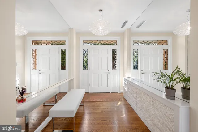 a living room with large window and a chandelier