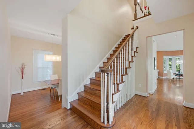 a view of entryway with wooden floor and stairs