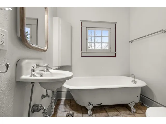 a bathroom with a sink a mirror and a bathtub