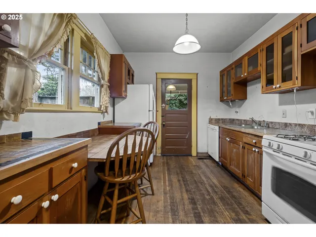 a dining room with a wooden table and chairs
