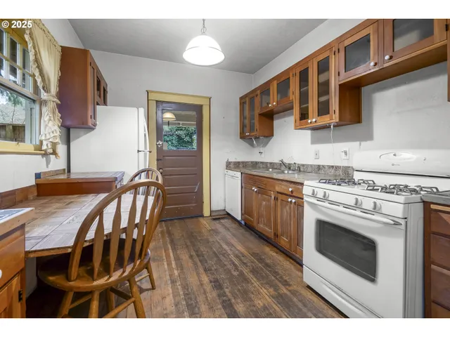 a kitchen with stainless steel appliances granite countertop a sink dishwasher stove and cabinets