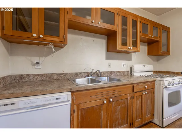 a view of kitchen with a window a refrigerator and a sink