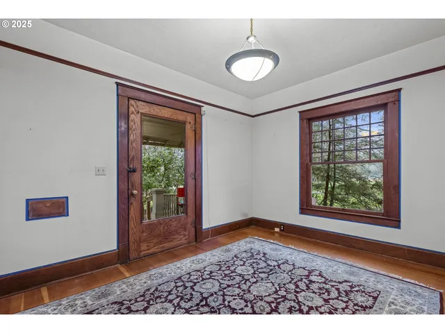 a view of a livingroom with wooden floor and a ceiling fan