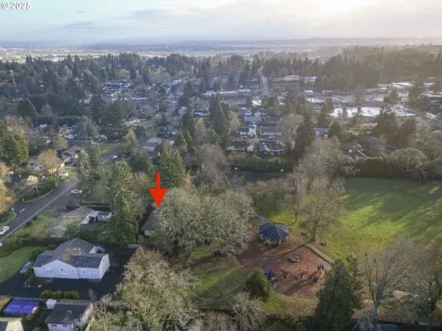 an aerial view of a house with a yard