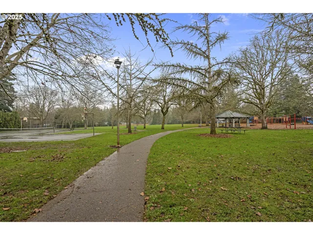 a view of a yard with a house and large trees