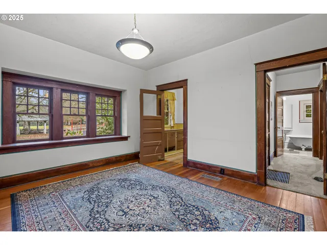 a view of wooden floor and windows in a room