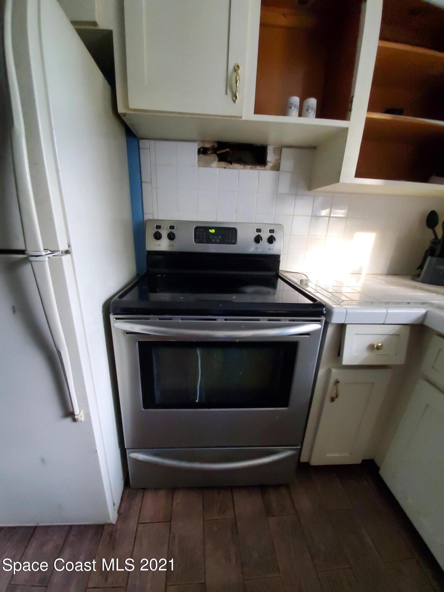 973 Macco Road Cocoa, FL 32927 - Photo 22 of 47 a stove top oven sitting inside of a kitchen