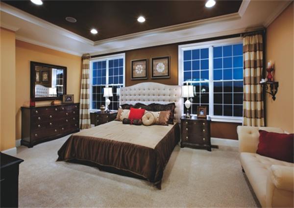 a bedroom with a large bed and a dresser