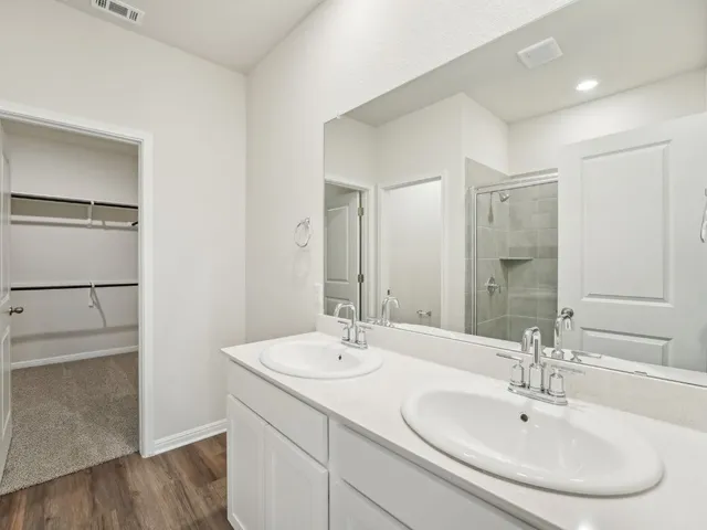 a bathroom with a shower sink and mirror