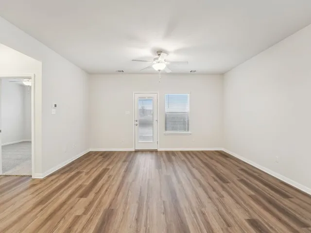 wooden floor in an empty room with a window