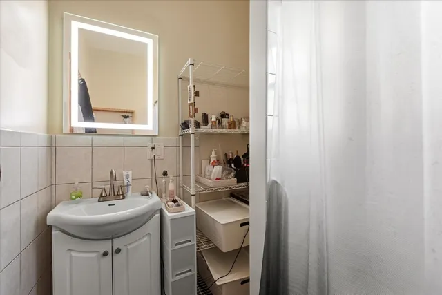a bathroom with a sink a toilet and a mirror